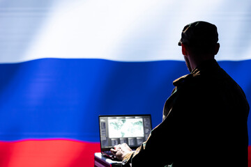 Russian federal security service operative engaged in surveillance mission using laptop, looking at world map. Russia military officer working for Kremlin regime monitoring zone of interest