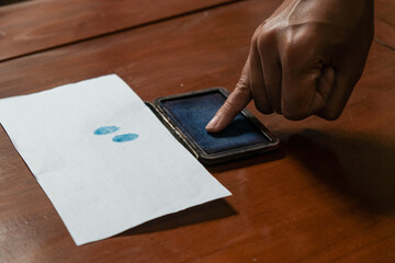 Finger man dipped in purple ink marks after the general election. presidential election day. Pemilu indonesia, Pilkada,  The finger dipped in purple ink