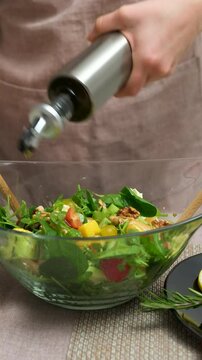 add olive oil to salad seafood lobster Hands only Caucasian home kitchen counter slicing organic fresh salad vegetables wireless tablet recipe healthy lifestyle eating