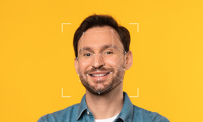 An individual stands against a bright yellow background, showcasing facial recognition technology. Geometric lines outline his facial features, emphasizing identity and technology.