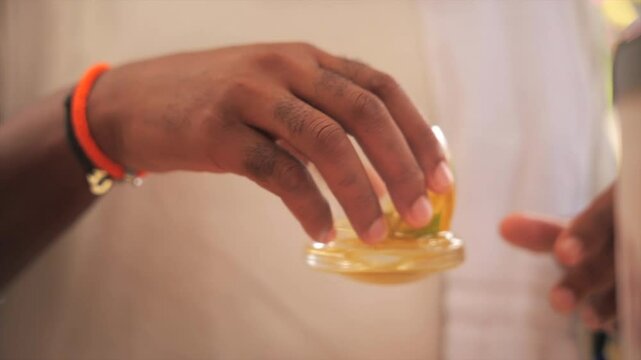 Man about to drink his rum drink/ti punch (Martinique)