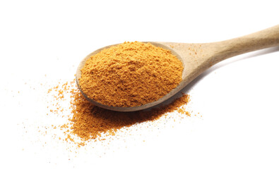 Mexican taco seasoning, pile in wooden spoon isolated on white, side view