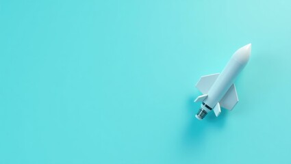 Turquoise dumbbell on right. White miniature rocket model on blue back