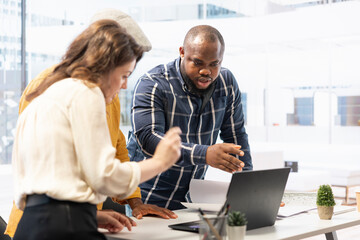 Realtor and broker meeting with the client to review blueprints and architecture plans in order to enhance her vision. Team of experts assisting business owner in property investing activity.