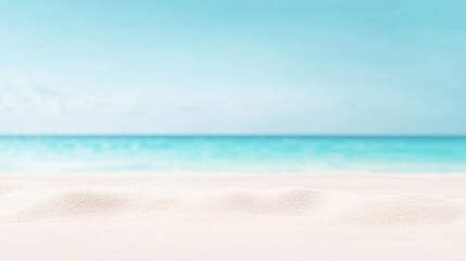Obraz premium Soft white sand creates a tranquil foreground against a backdrop of vibrant turquoise ocean water, blurred for effect, under a clear blue sky, evoking a serene and idyllic summer beach scene
