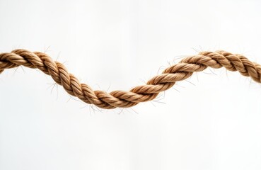 Closeup view of light brown rope forming wave-like pattern isolated on white background. Rope natural texture with visible strands. Image suitable for design elements, nautical themes, decorative
