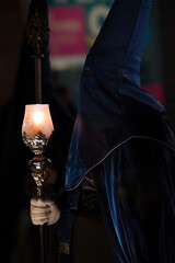 Nazarenes in blue, with a lantern and a candle, to illuminate the streets of Cartagena, in the Holy Monday procession