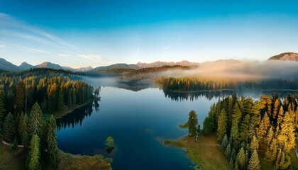 Fototapeta premium aerial shot of a tranquil lake in the morning