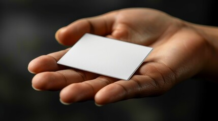 A hand holding a white card with no writing on it