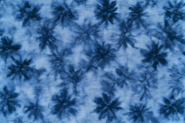 Abstract Tie-Dye Pattern Forms Intricate Blue Floral Designs on Fabric Seamlessly