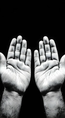 Open Hands Reach Outward in Black and White Photo, Symbolizing Hope and Prayer, Against Dark Background.