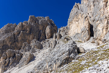 Via ferrata in the Dolomites. Equipped with bridge and steel cable hiking and climbing path in the high rocky mountains in Dolomiti Alps. Historical and extreme passages between the mountain cliffs an