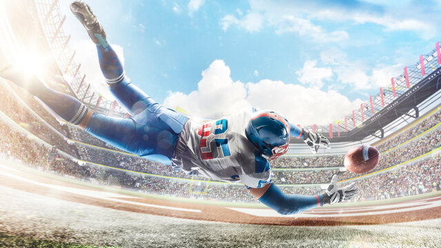 American football. Player catches the ball and flies in the air. Back view. Sportsman in action. Professional stadium with lights and fans