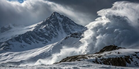Obraz premium Majestic mountain range with powerful snowstorm sweeping across icy landscape during winter