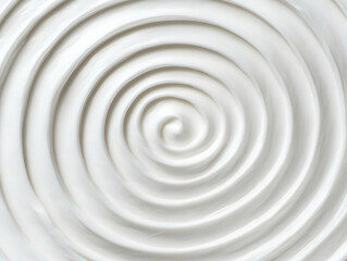 White cream forms a smooth, swirling pattern, creating an abstract texture visually.