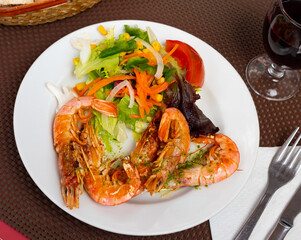 Appetizing shrimp with fresh vegetable salad served on platter