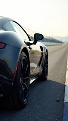 Sleek black sports car on a sunny racetrack day