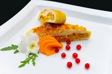 A delicious vegetable pie is elegantly presented on a white plate.