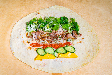 Delicious wrap preparation with fresh vegetables and grilled meat