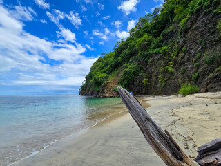 Blanca Beach and the blue waters of Culebra Bay, lush green trees, blue sky and clouds in Liberia Guanacaste Costa Rica