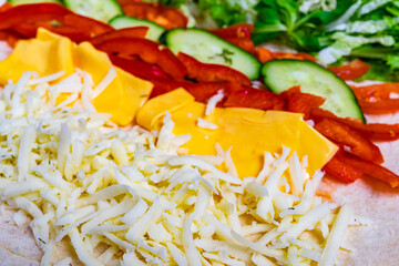 Freshly prepared colorful vegetables and cheese for a wrap
