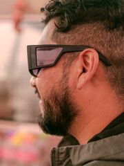 male person with beard and glasses with his face in profile 