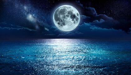 Romantic full moon rising over ocean at night