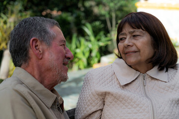 Fototapeta premium Sky, elderly couple and hug outdoors or happy in retirement or husband and wife in nature. Mature, man and woman smile in vacation or senior citizens care and embrace or date at the park for romance