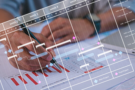 Time and project management concept businessman using pen and paper data chart working analysing and planning for workflow and schedule