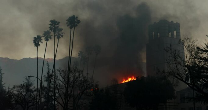 Altadena, California, USA - January 8, 2025: Aided by extreme Santa Ana wind conditions, the Eaton Fire engulfs a church in downtown Altadena.