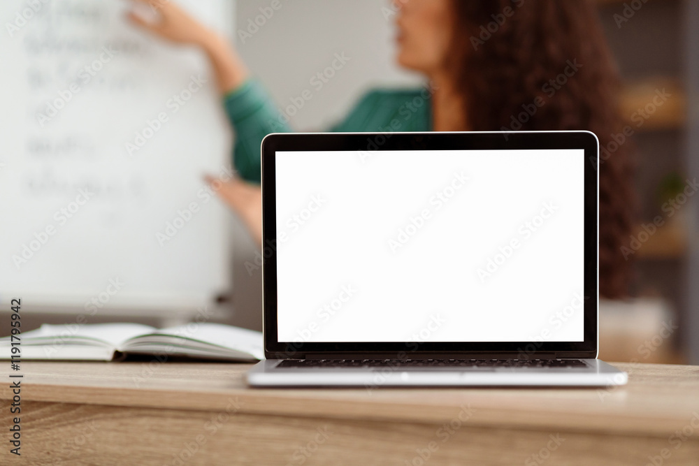 Poster E-learning Course, Remote Education. Selective focus on blank white laptop screen on table, mock up. Lady teacher shooting video lecture using computer having chat with students, explaining material