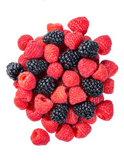 Large pile of red and black raspberries and blackberries - close-up from above on transparent background