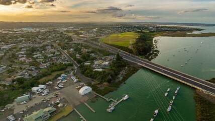 Aerial view of a marina, Northwestern Motorway, and residential area. Boats are moored at docks, traffic flows on the highway. WHAU RIVER, AUCKLAND, NEW ZEALAND