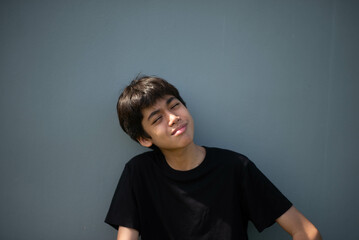 Fototapeta premium Teenage Boy's Expressions Collage: A captivating grid showcases a young Asian boy's diverse facial expressions, capturing a range of emotions from joy to contemplation.