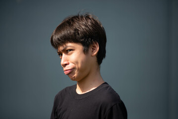 Teenage Boy's Expressions Collage: A captivating grid showcases a young Asian boy's diverse facial expressions, capturing a range of emotions from joy to contemplation.