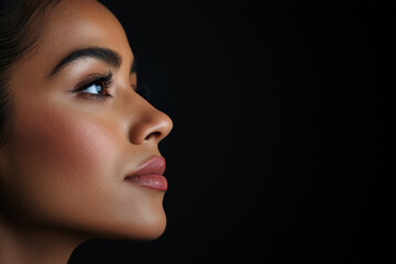 Profile portrait of a woman showcasing natural beauty and elegance in dim light