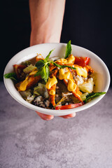 Stir fried chicken and vegetables with fresh greens on a plate