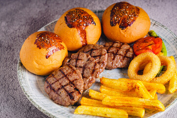 Grilled sausages with vegetables and potatoes on a white plate