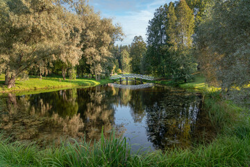 A wooden bridge over the pond "Under the shade of thick Willows" in the Mikhailovskoye estate of the Pushkin Museum-Reserve, Pushkinskiye Gory, Pskov Region, Russia