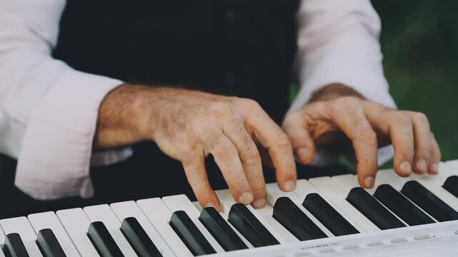 Professional pianist. The pianist performs playing a grand piano. Hands close up