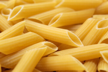 close-up of pile of raw penne pasta