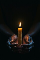 A serene photograph of an African American man holding a glowing candle, perfect for events like memorials, Black History Month, or remembrance campaigns.