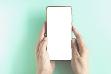Concept for business online, blogger, and advertising. Hand-holding smartphone shows a white screen display on brown background. Top view, flat lay with copy space..