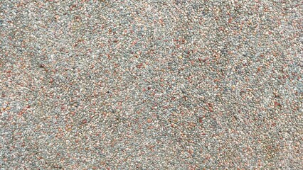 small stone texture background on cement wall. Abstract marble wall texture for background. Background of gravel stones in various shapes and colors