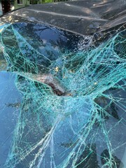 An Intricate Close Up View of Cracked Glass Featuring a Unique Spiderweb Pattern Design