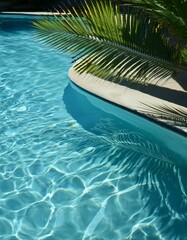 Palm fronds cast shadows on a tranquil blue pool.