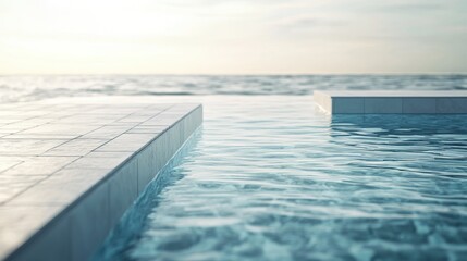 Obraz premium Oceanfront pool steps, tranquil water, sunset