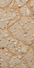 A textured surface resembling sandy or pebbled material.