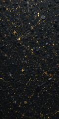 A textured black surface with golden specks, resembling a starry night sky.