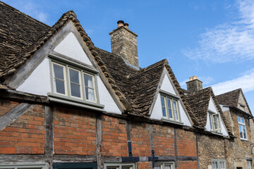 Dormer roof and windows in row on half-timbered brick house